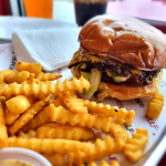 Wulf Burger smash burger with red bun in Dallas