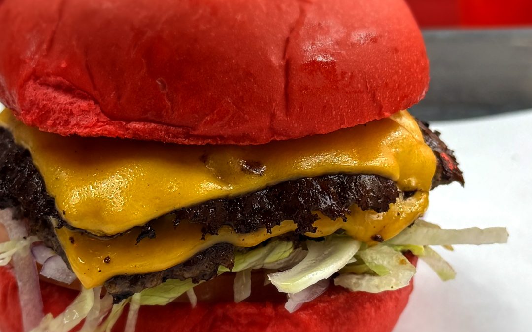Loaded double smash burger with melted cheese at Wulf Burger Dallas TX