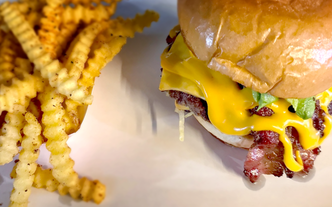 Loaded double cheese burger from Wulf Burger in Dallas Texas with fresh toppings and premium beef patties