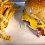 Loaded double cheese burger from Wulf Burger in Dallas Texas with fresh toppings and premium beef patties