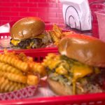 Wulf Burger double smash burger with red bun in Dallas Texas