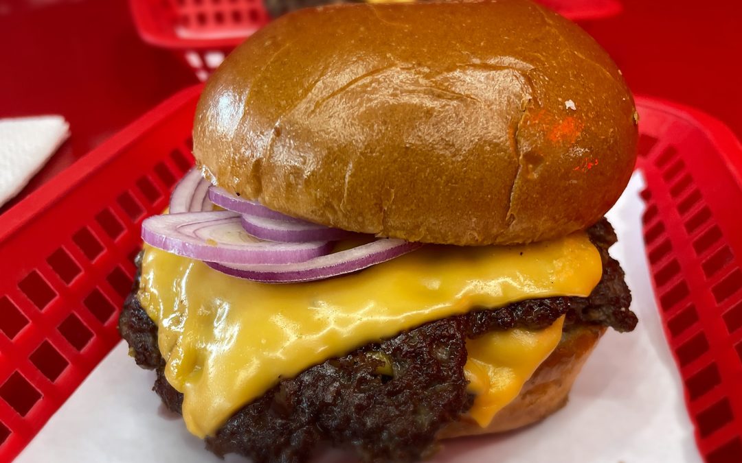 Wulf Burger red bun burger made with natural ingredients and hormone-conscious beef in Dallas Texas