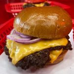 Wulf Burger red bun burger made with natural ingredients and hormone-conscious beef in Dallas Texas