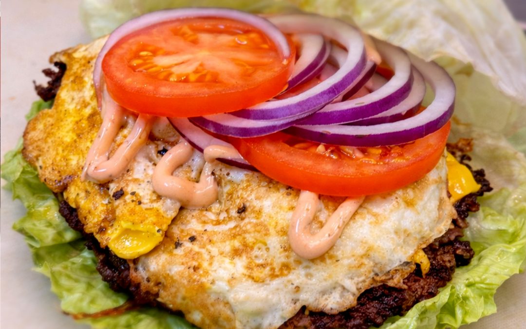 Wulf Burger bunless Protein Stacks with double beef patties, melted cheese and fresh vegetables in Dallas Texas