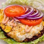 Wulf Burger bunless Protein Stacks with double beef patties, melted cheese and fresh vegetables in Dallas Texas