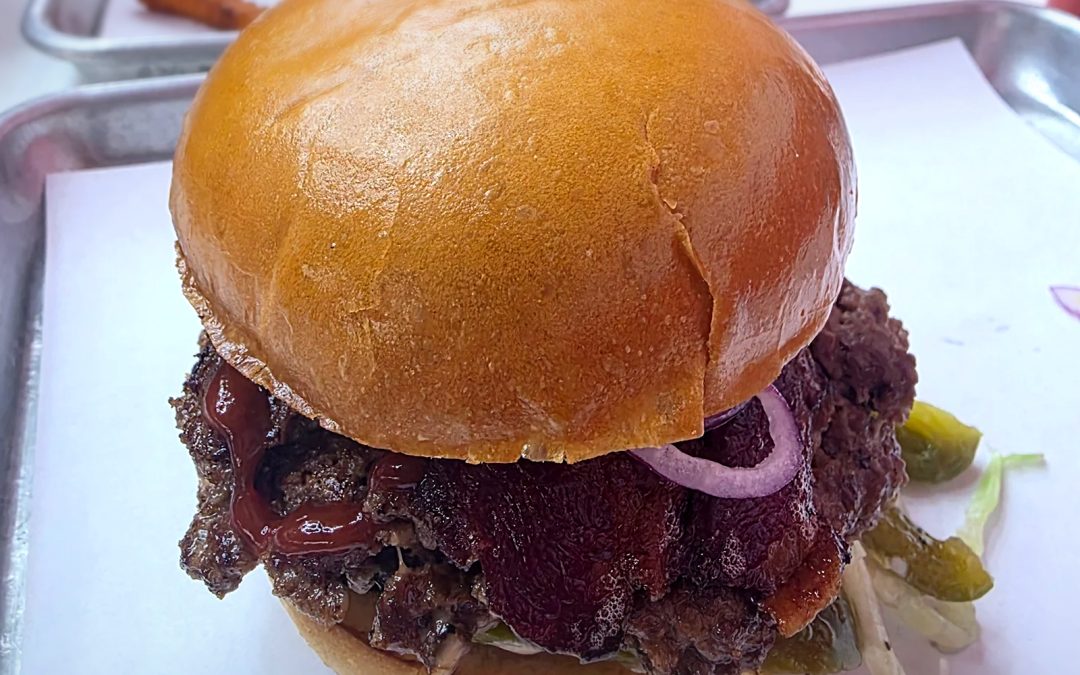 Wulf Burger viral smash burger with red bun in Dallas Texas