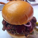 Wulf Burger viral smash burger with red bun in Dallas Texas