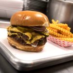 Wulf Burger double smash burger with red bun in Dallas Texas